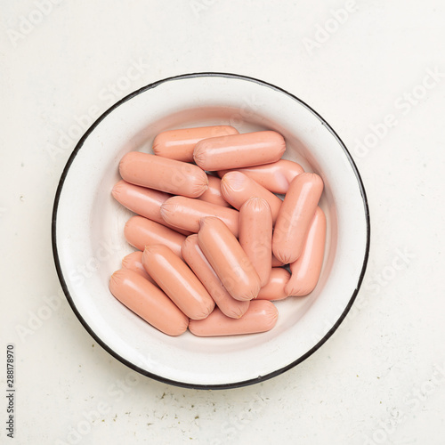 Photography raw sausages in old metal bowl