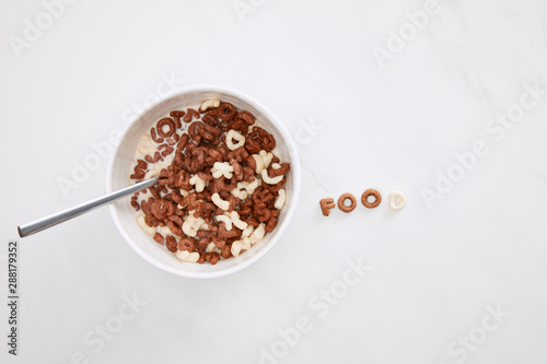 top view of cereal food inscription near bowl on marble surface