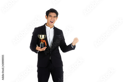 Handsome young businessman Asian caucasian wear a black suit with black hair, be a smile and standing smart poses. Hold a trophy. On a white background.