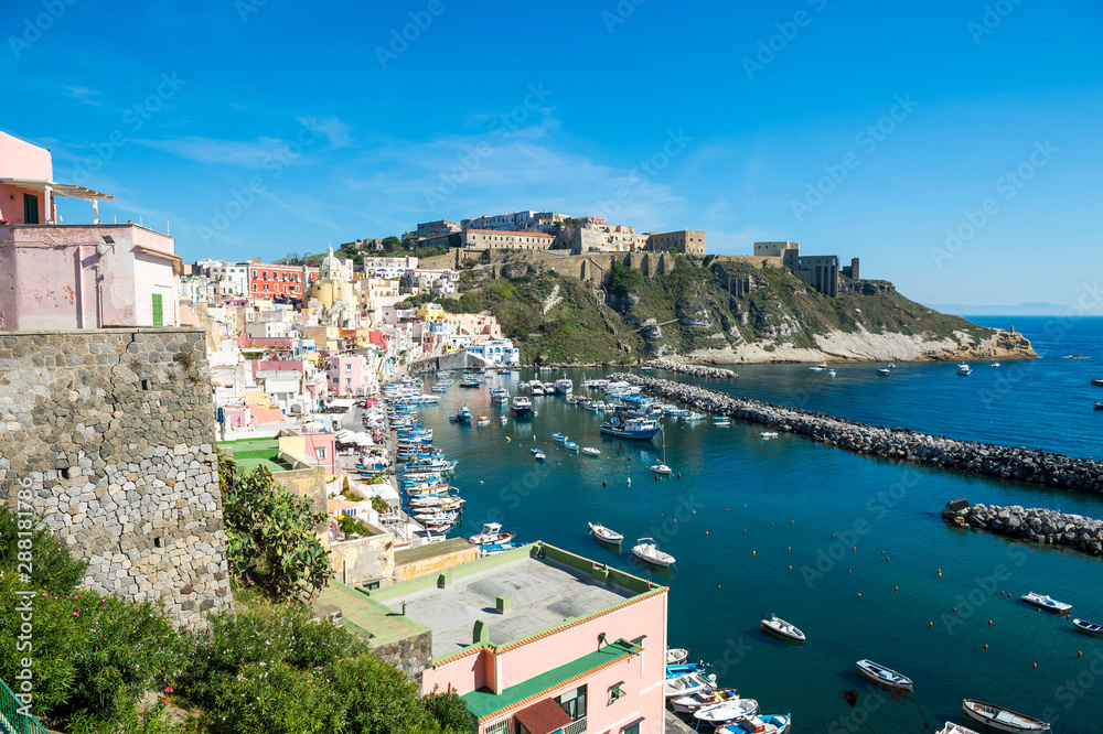 Bright morning view of picturesque Marina Corricella harbour village on the island of Procida, a day trip from the port of Naples, Italy