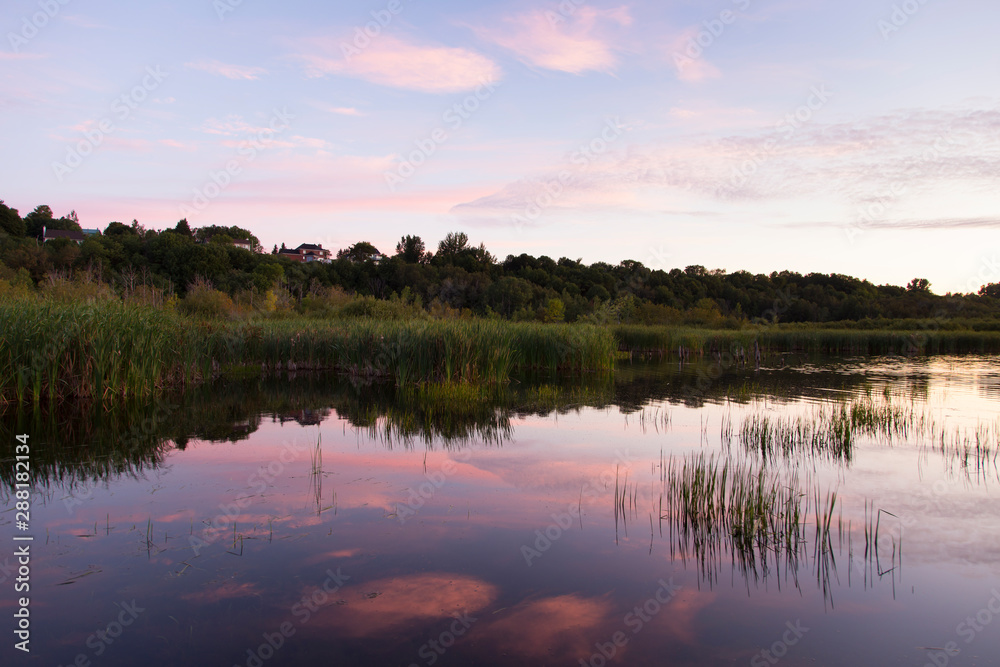 Fototapeta premium Pretty pink sunrise on the Léon-Provancher marsh during late summer, Neuville, Quebec, Canada, Neuville, Quebec, Canada