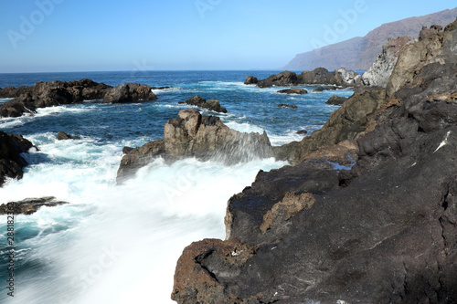 Water rushing over rocks in the ocean in Tenerife, Spain