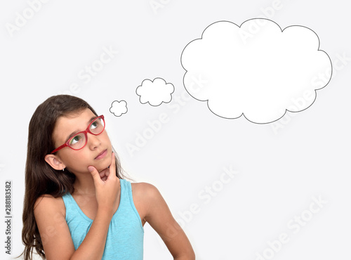 Thoughtful young girl wearing glasses with an empty thought bubble