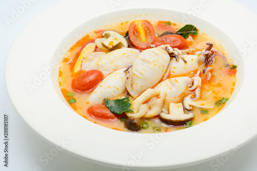 Squids and lemon grass spicy soup with mushrooms, tomatoes and herbs