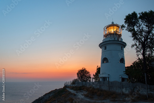 White sea lighthouse in Feodosia  Crimea on the Black Sea from the light under the evening sky