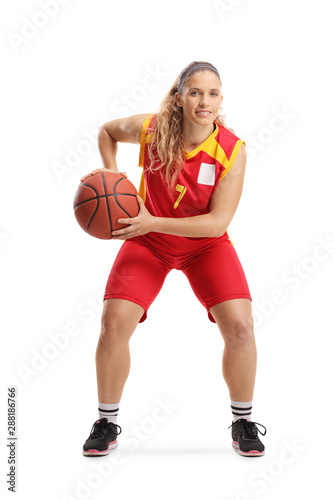Professional female basketball player in a red jersey