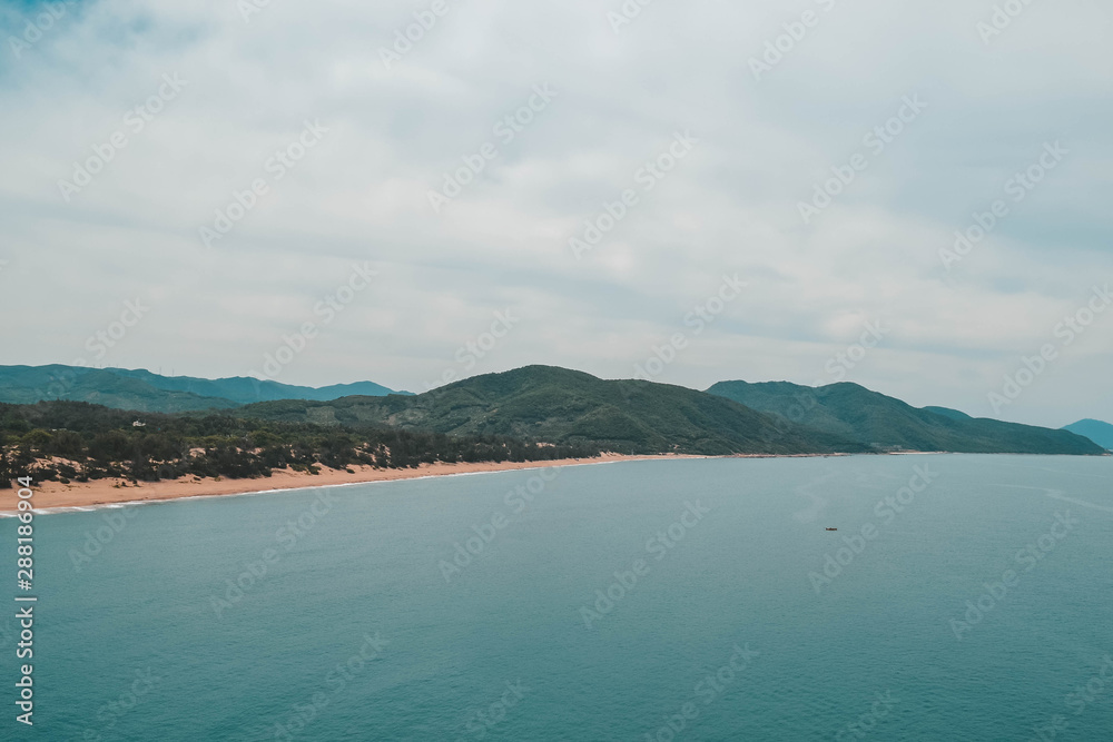 Green ocean shore and beach in Hainan island, China.