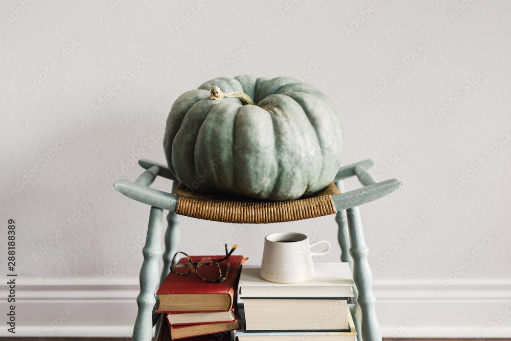 © Kelly Knox/Stocksy - pumpkin, coffee, and books