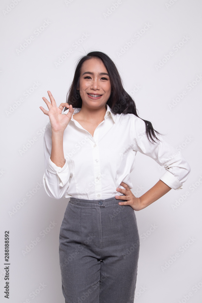 Young Asian woman show OK sign.