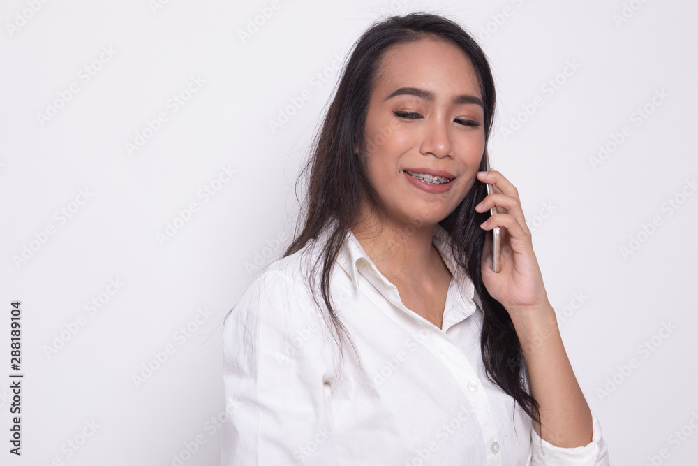 Young Asian woman talking with mobile phone. Young Asian woman talking with mobile phone.