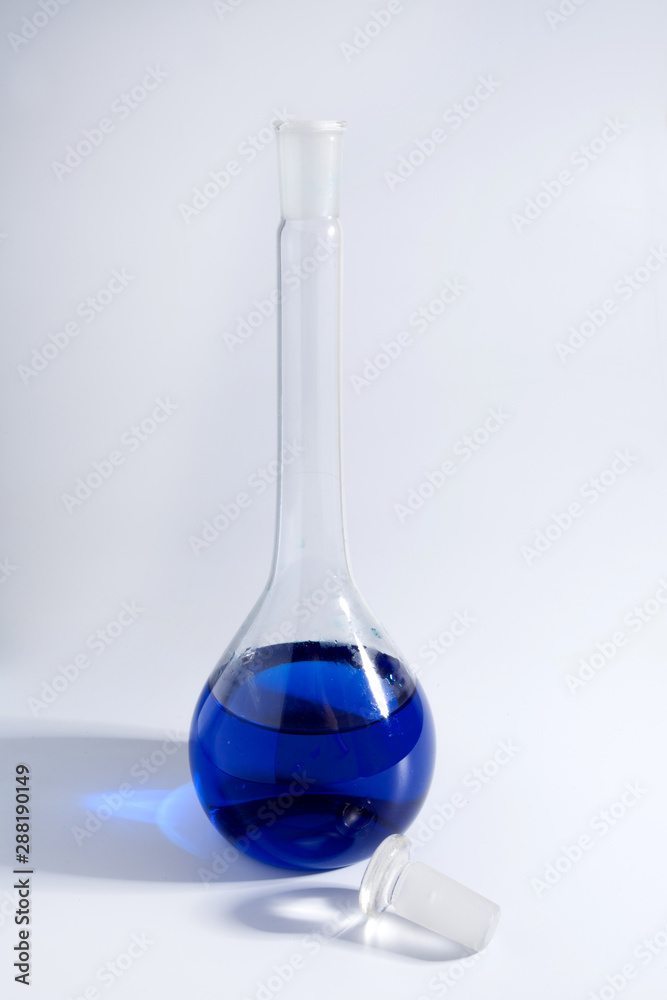 glass test-tube with colored liquid and smoke at green background glass test-tube with colored liquid and smoke at green background