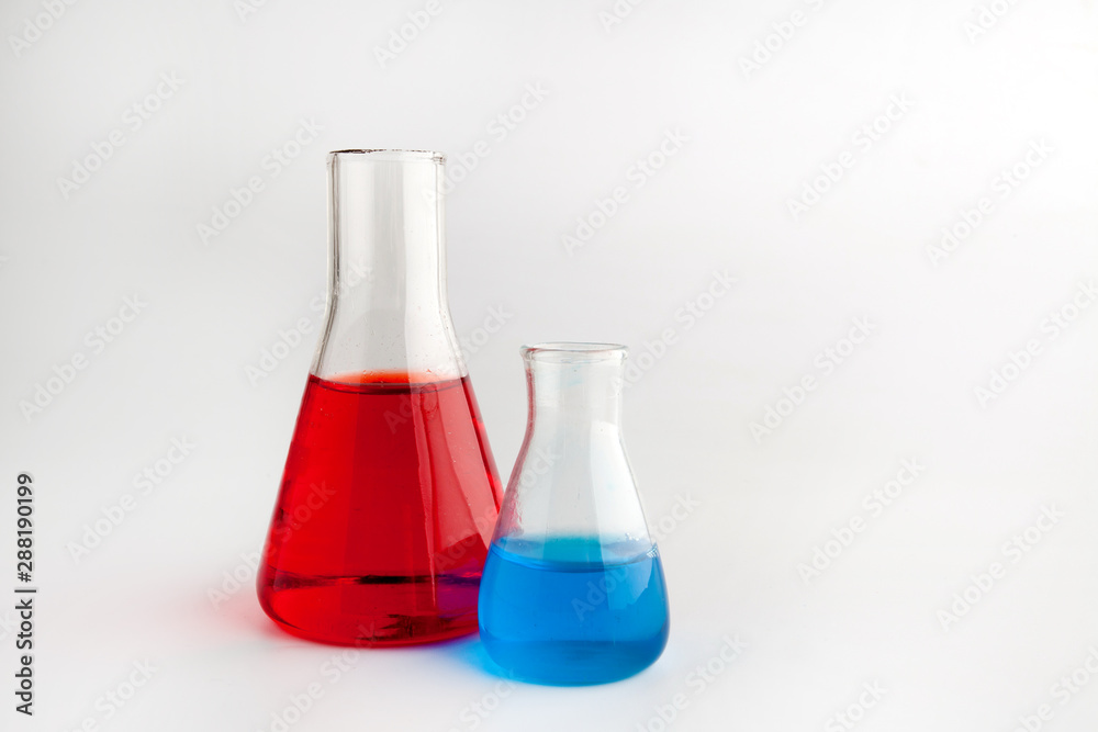 glass test-tubes with colored liquid and smoke at green background glass test-tubes with colored liquid and smoke at green background
