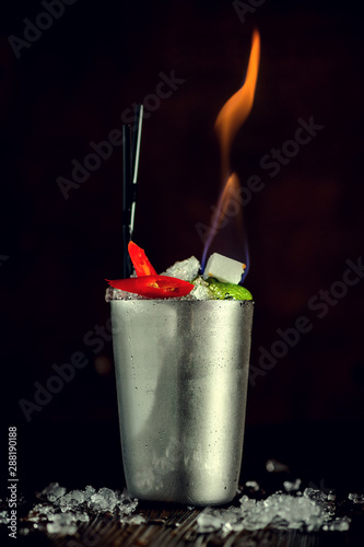 Cocktail. Mint Julep drink with orange in copper glass and steel straw