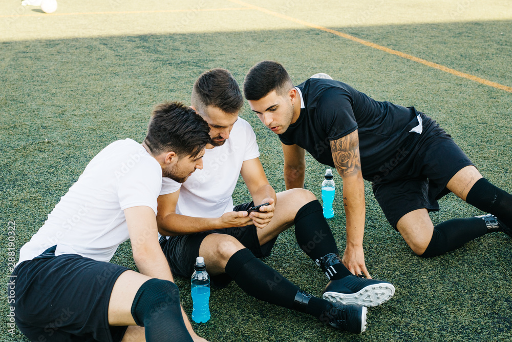 Soccer players looking phone Soccer players looking phone