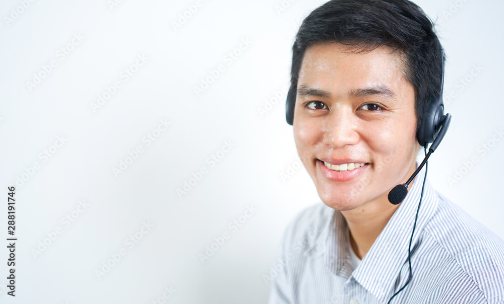 close up call center employee young asian man wear headset device and smiling with pointing hand on white background for business telemarketing and help desk design concept close up call center employee young asian man wear headset device and smiling with pointing hand on white background for business telemarketing and help desk design concept