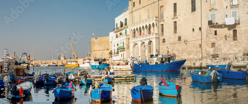 Obraz na plátně Monopoli, Puglia Italy - Thursday 22 August 2019: Boats moored at the old port o
