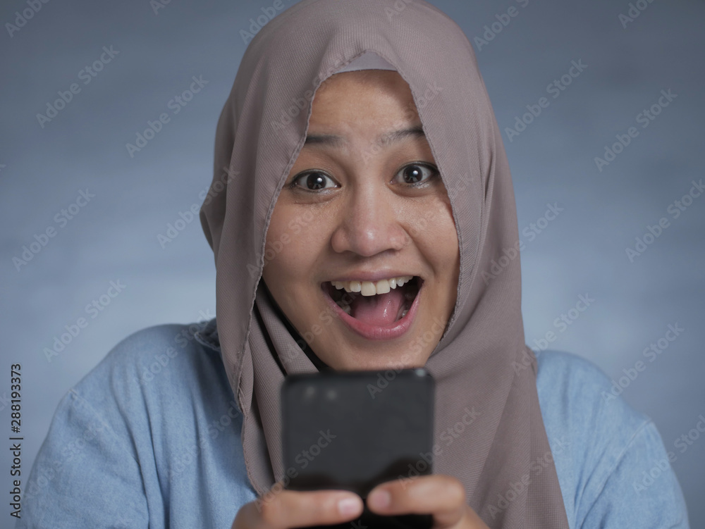 Young Muslim Woman Get Good News on Her Phone Young Muslim Woman Get Good News on Her Phone