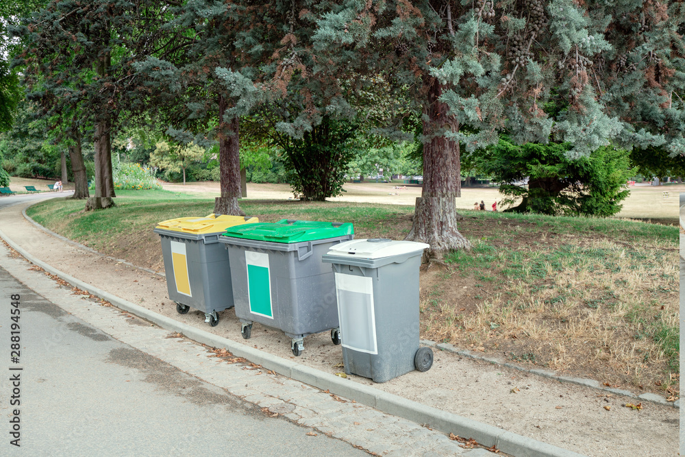 A group of Garbage conteiners in the city park A group of Garbage conteiners in the city park