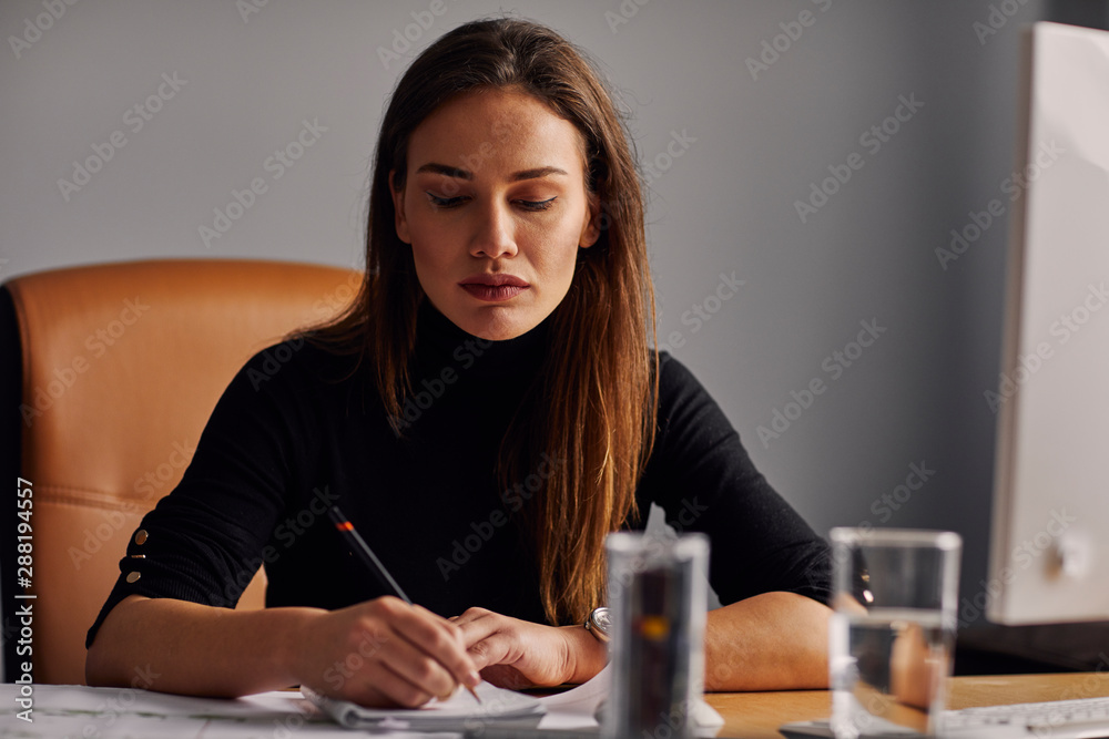 Business woman at her office working on a computer Business woman at her office working on a computer