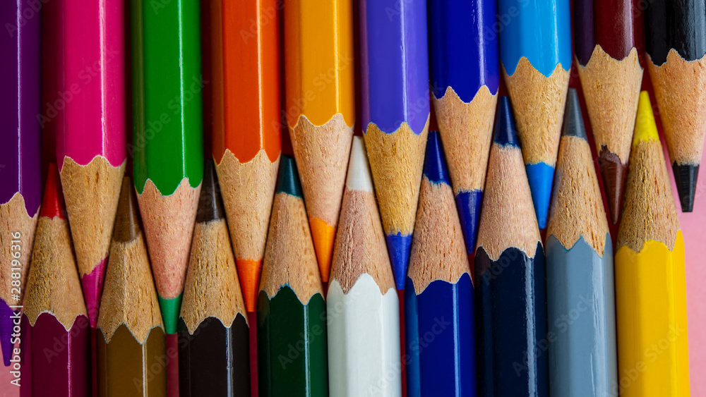 Fototapeta premium multi-colored pencils in a set lie against each other.