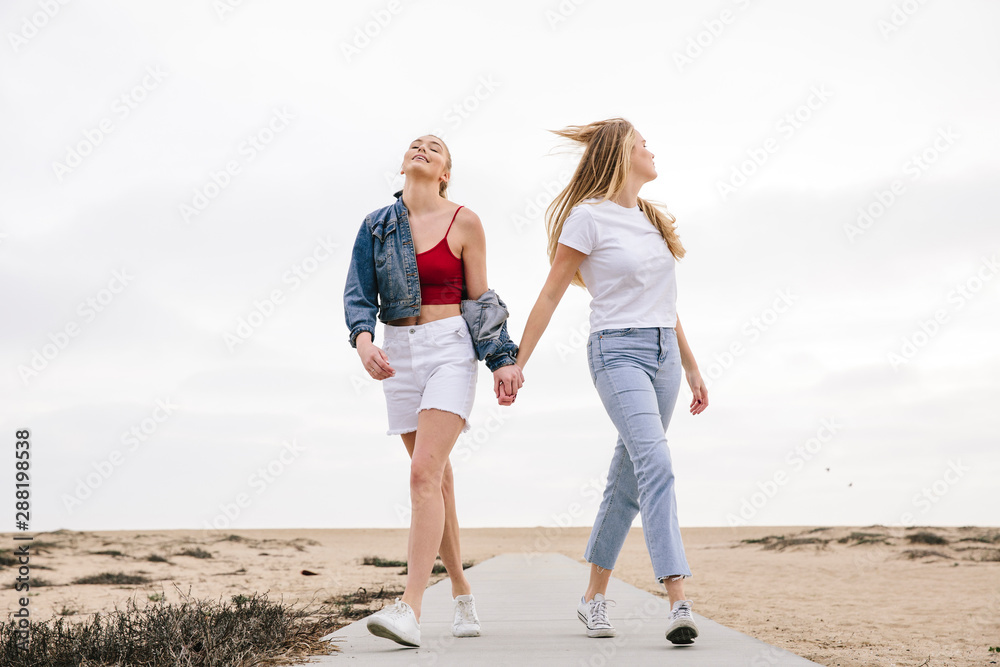 Two girls walking at the beach Two girls walking at the beach