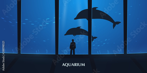 Big Aquarium or Dolphinarium With dolphin. People with children watching the underwater world.