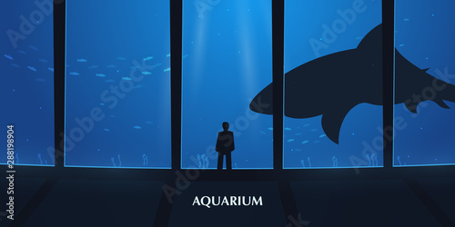 Big Aquarium or Oceanarium With shark. People watching the underwater world.
