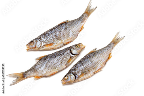 Dried fish-Rutilus rutilus lacustris - on the table. Salty dry fish on white background. Isolated on white background.
