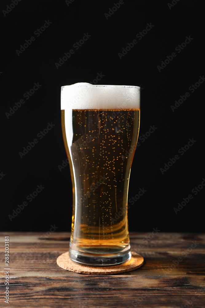 Mag with beer on wooden table, space for text