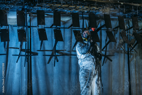 Worker painter at industrial factory