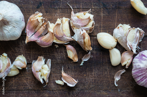 smashed garlic on a wooden board photo