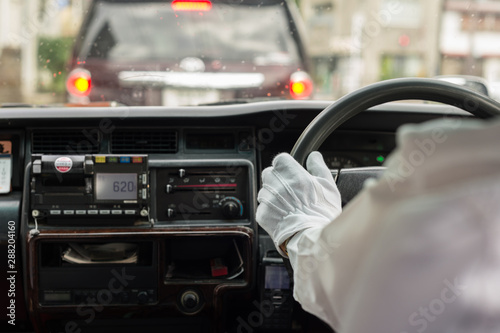 gloved hand of japanese taxi driver