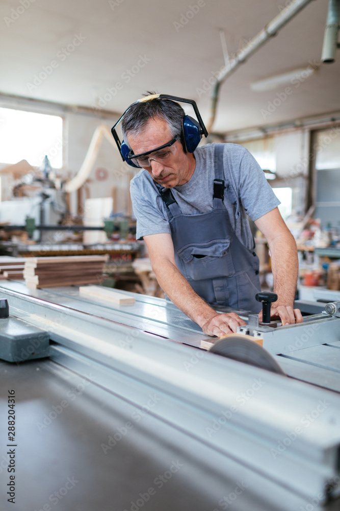 Carpenter working in a workshop Carpenter working in a workshop