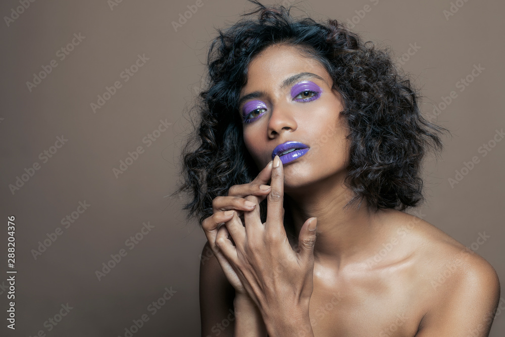 Closeup portrait of an Indian model with bold eye makeup and lipstick looking at camera. Makeup portrait for eye makeup and lipstick. Closeup portrait of an Indian model with bold eye makeup and lipstick looking at camera. Makeup portrait for eye makeup and lipstick.