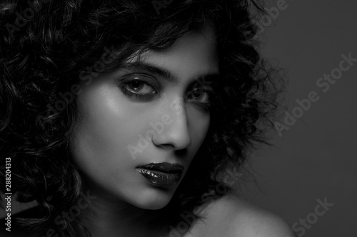 Closeup portrait of an Indian model with bold looking at camera. Black And White portrait .