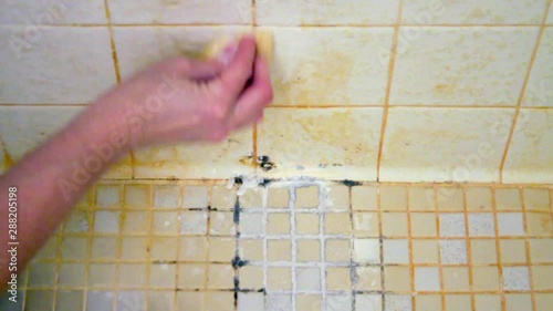 Starting to clean a disgusting shower floor that is covered in soap scum, mildew, and mold.