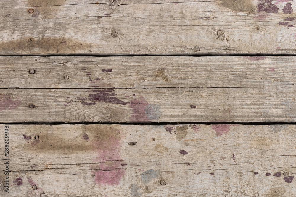 Old gray-brown natural wood background in the form of a board with cracks, knots and a rough surface Old gray-brown natural wood background in the form of a board with cracks, knots and a rough surface