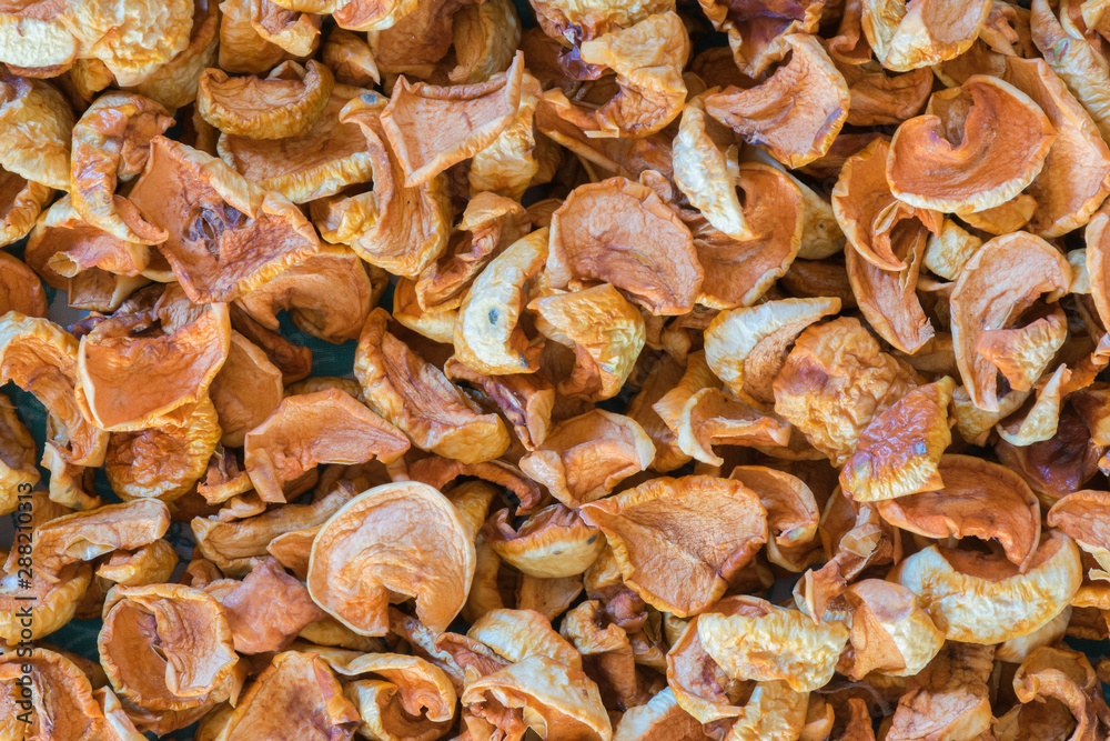 Dried fruits apples and pears scattered on the canvas as a background Dried fruits apples and pears scattered on the canvas as a background