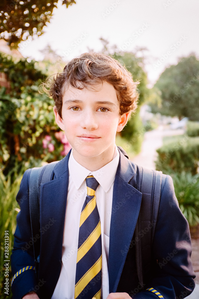 teenage-boy-in-a-school-uniform-with-backpack-stock-photo-adobe-stock