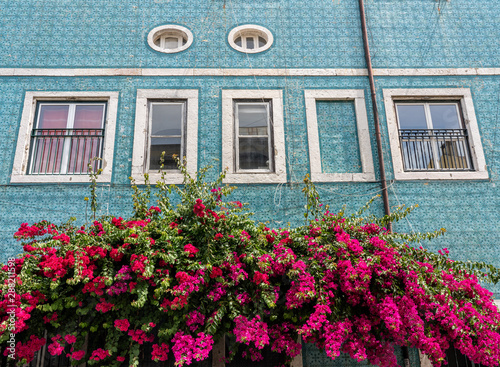 Decorative ceramic tiles on a large house with colorful flowers in Alfama district of Lisbon, Portugal