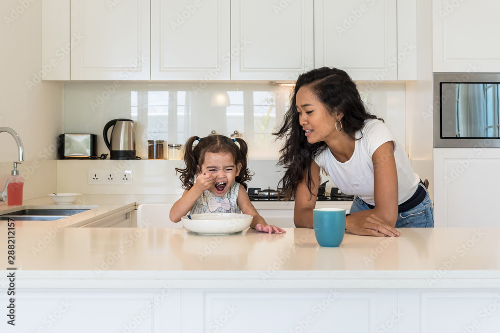 Mother and daughter having breakfast in the kitchen Mother and daughter having breakfast in the kitchen