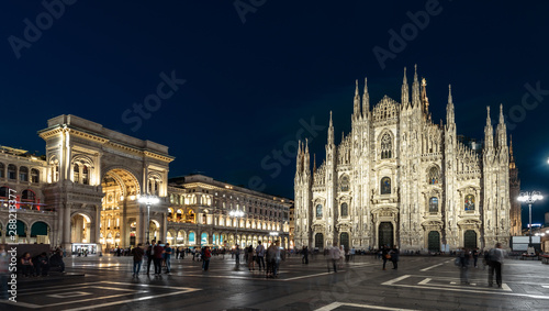 Milan Cathedral or Duomo di Milano at night, Italy. Panorama of Cathedral Square at dusk. Long exposure of Milan city center with blurred people.