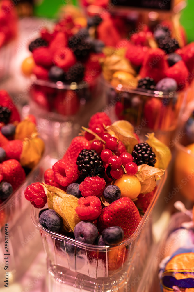 Close up of a plastic container filled with berries in the Boqueria market Close up of a plastic container filled with berries in the Boqueria market