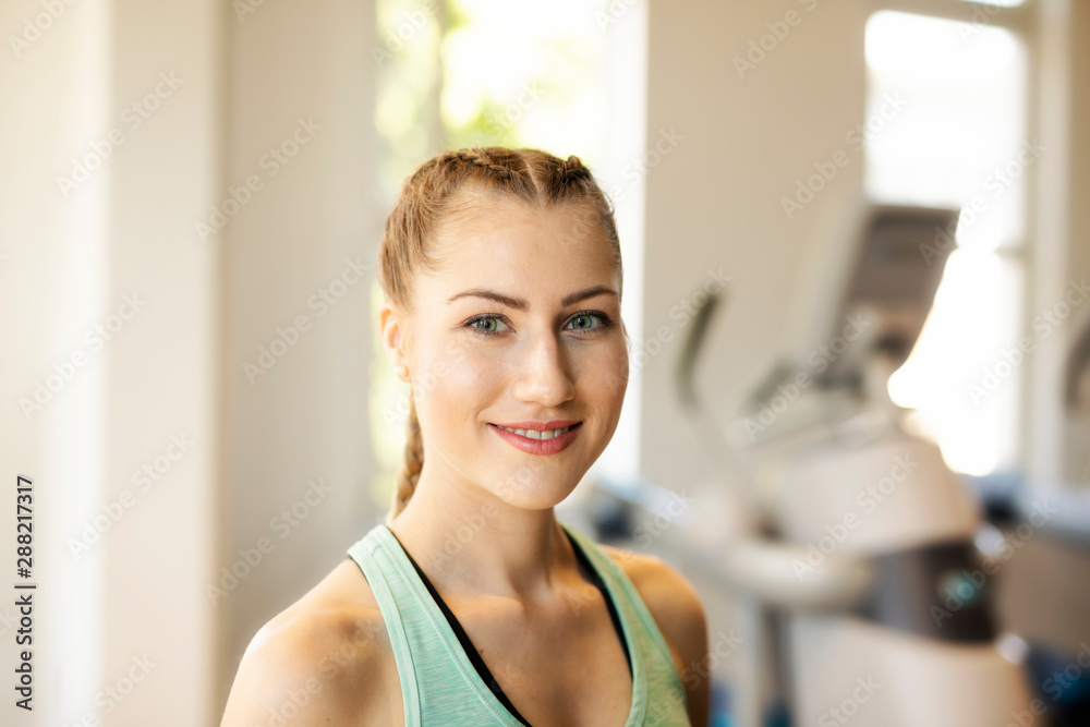 Portrait of smiling young woman in a gym