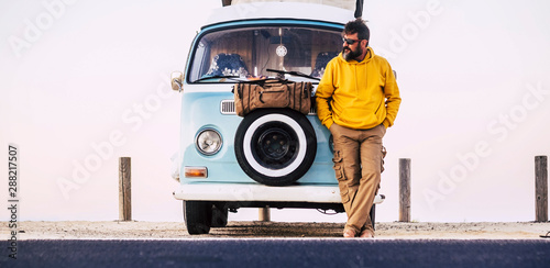 Mature man standing on van, Fuerteventura
