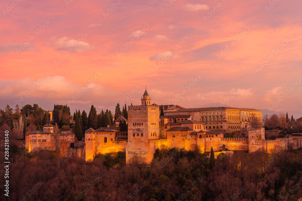 View of Alhambra with mountain Sierra Nevada in the background at sunset, Granada, Spain View of Alhambra with mountain Sierra Nevada in the background at sunset, Granada, Spain