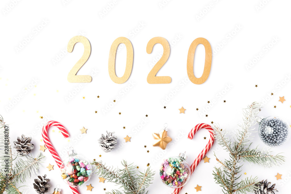 Christmas frame made of fir branches, cones, gold stars and decorations. Christmas wallpaper. 2020 background isolated on white. Flat lay, top view, copy space
