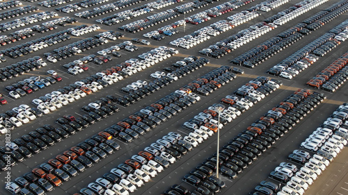 storage parking area with cars sorted by color in summer