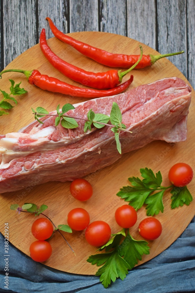 Fresh raw meat and pepper on a wooden background. Fresh raw meat and pepper on a wooden background.