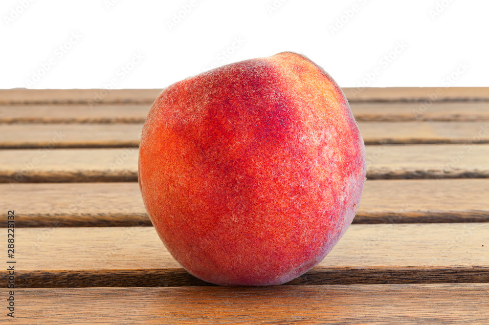 Peach lies on natural wooden boards. Close-up. Peach lies on natural wooden boards. Close-up.